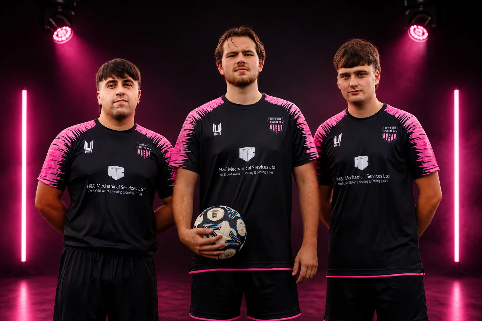 Three South Gyle Rovers players in black and pink Unite kit under pink studio lights